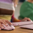 mx-anywhere-3s-rose-person-using-a-wireless-mouse.webp
